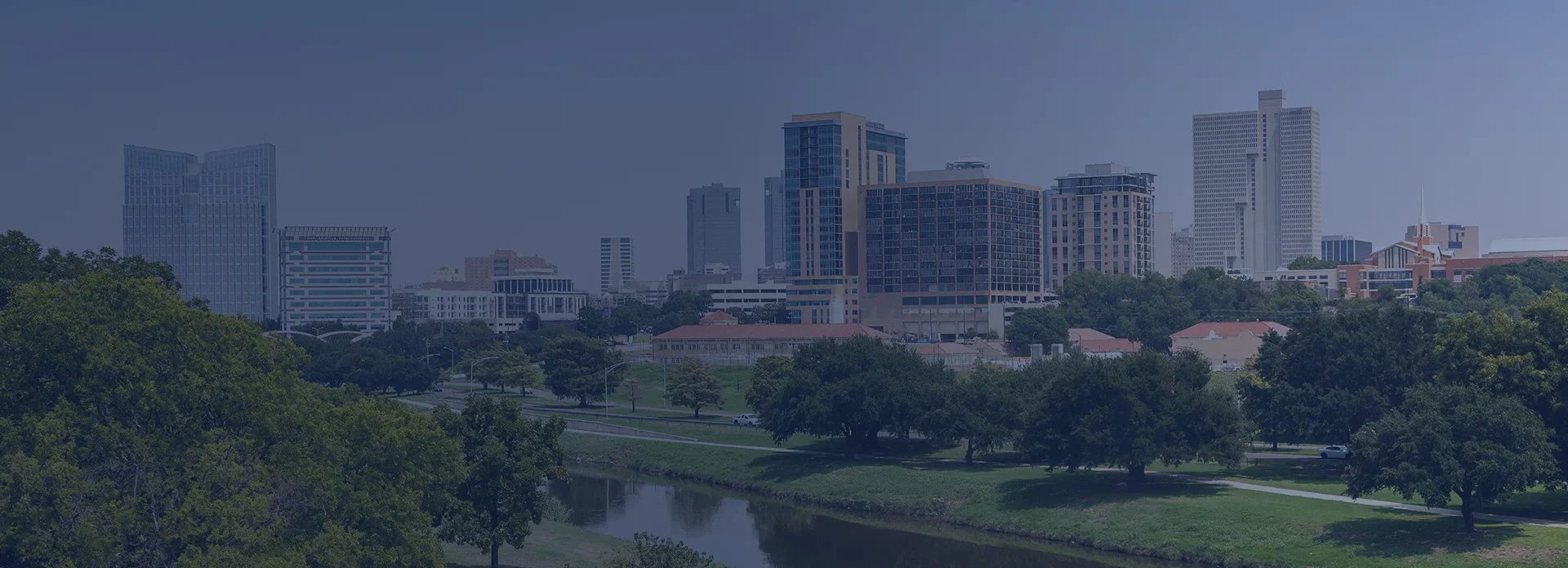 Downtown Fort Worth skyline with Trinity River and green park in the foreground